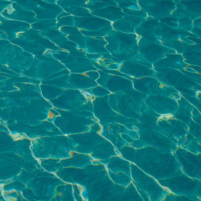 Abstract image of calm water ripples in teal color.