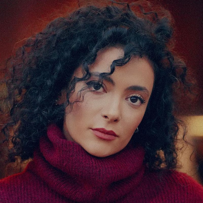 Close-up of a person's eye looking intently towards a light source.